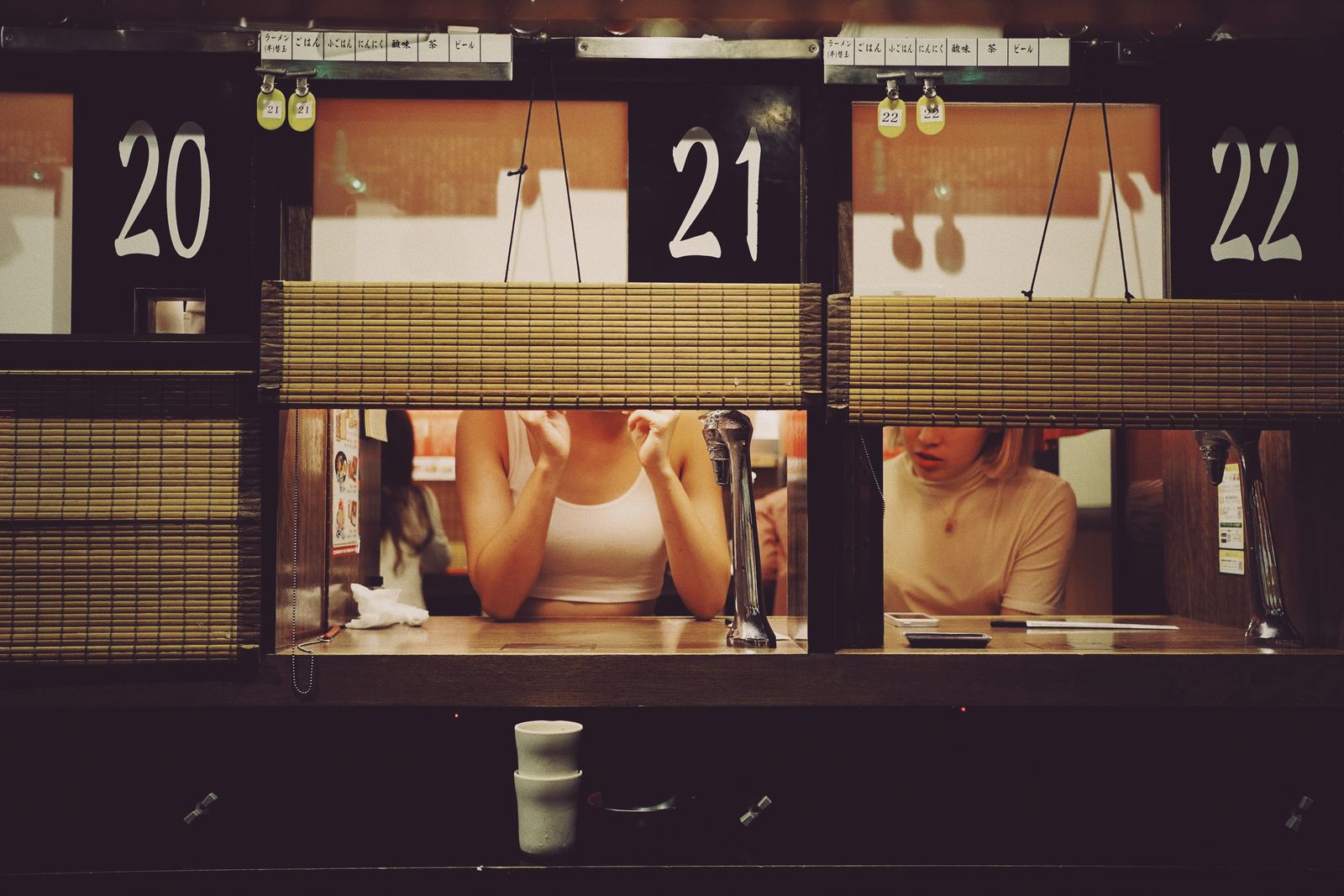A guest at the counter talking to a cook