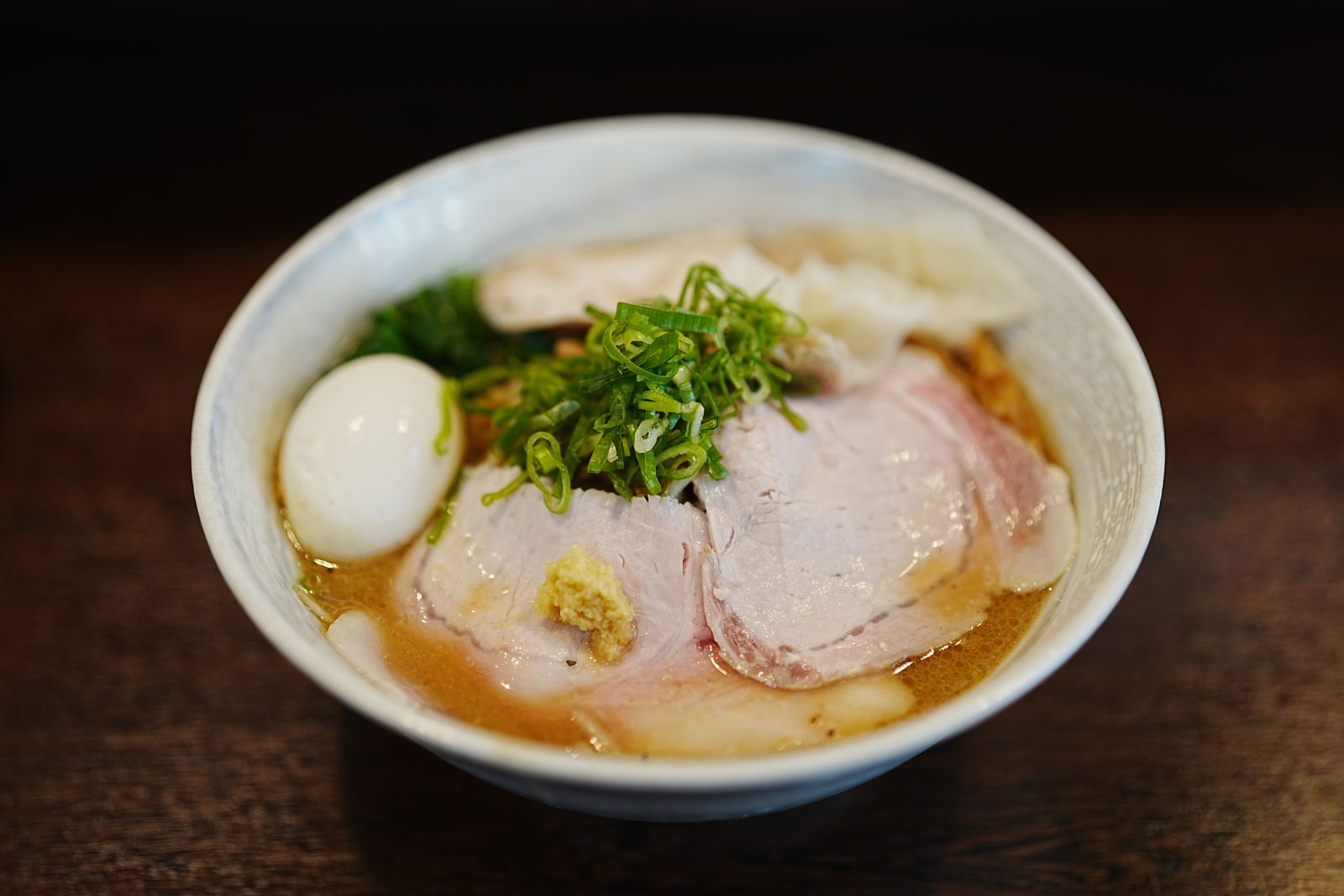 A bowl of tonkotsu ramen with chashu, ajitama and scallion