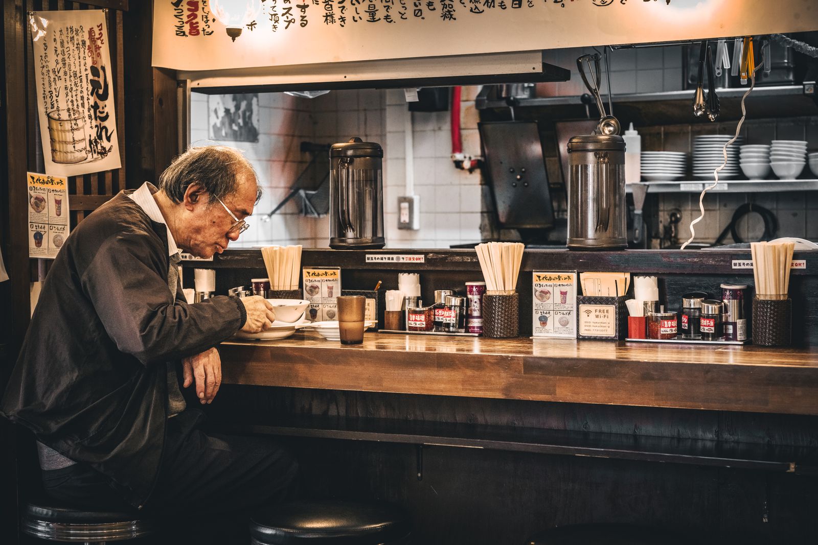 The counter at the Kakaako shop with guests eating ramen
